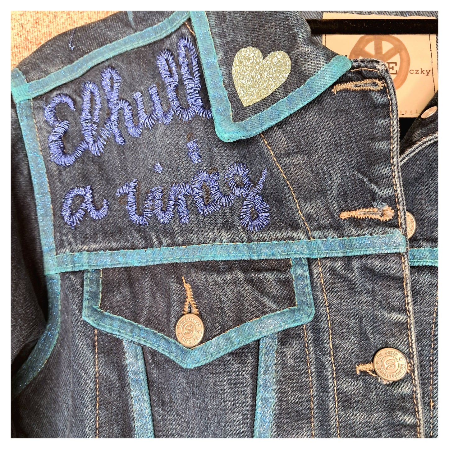 Recycled, upcycled blue denim jacket with hand embroyed with glitter skull on back