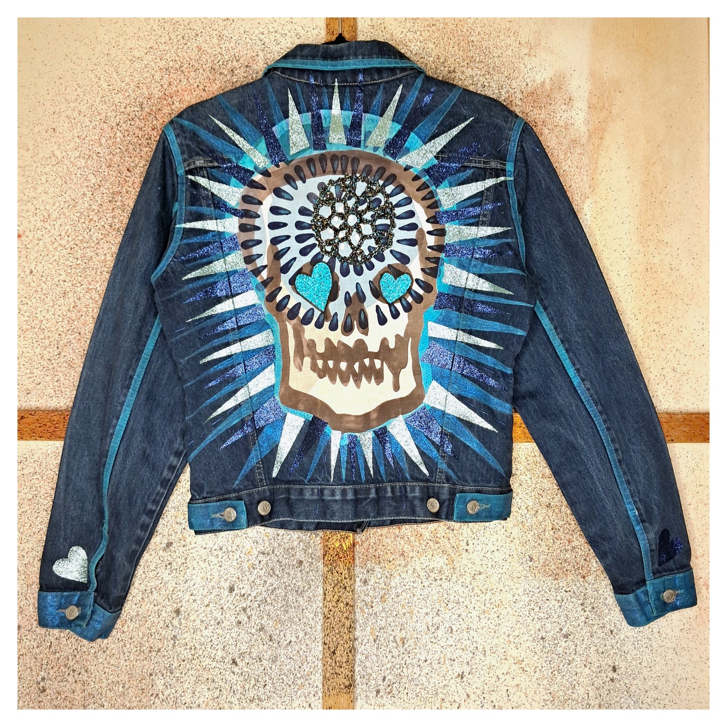 Recycled, upcycled blue denim jacket with hand embroyed with glitter skull on back