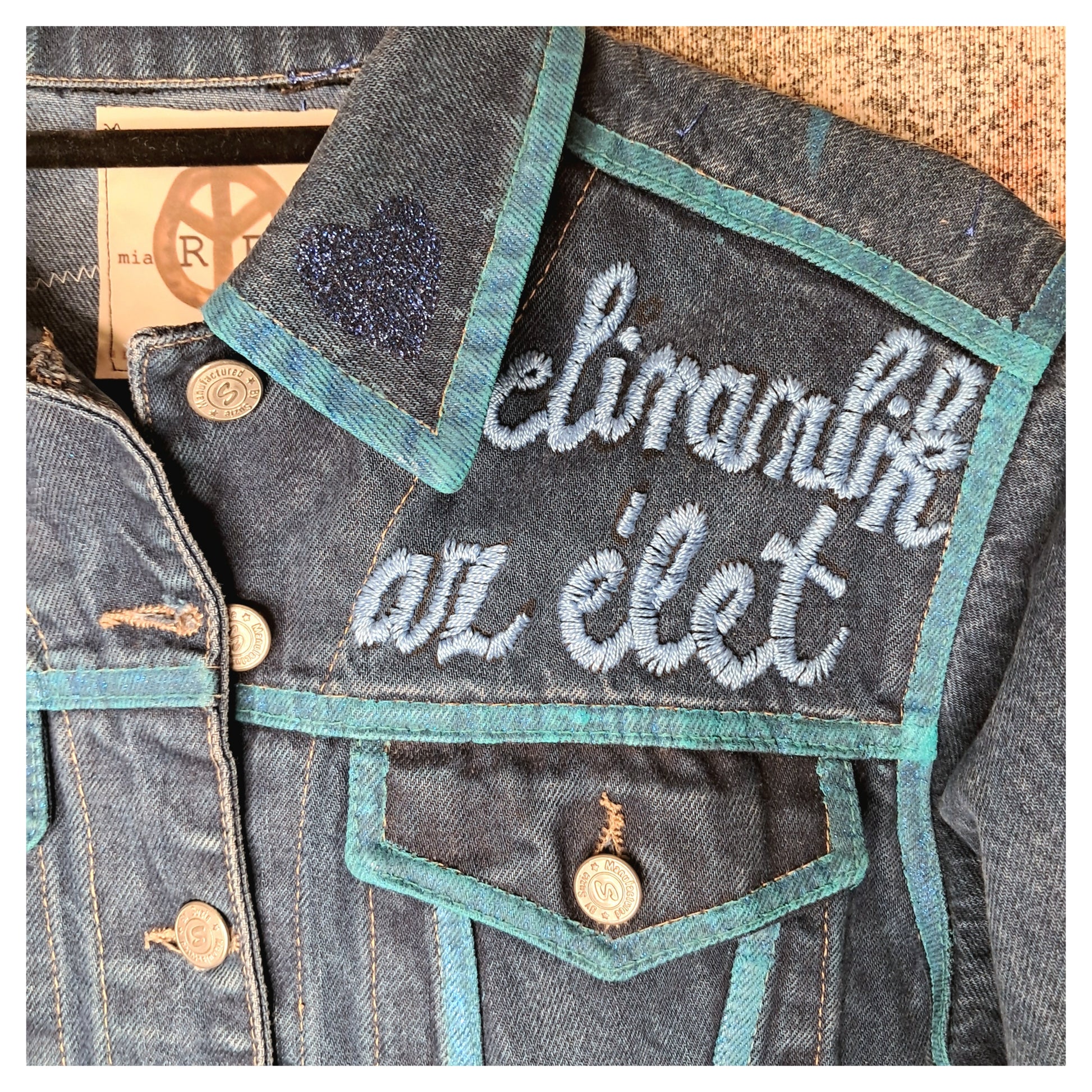 Recycled, upcycled blue denim jacket with hand embroyed with glitter skull on back