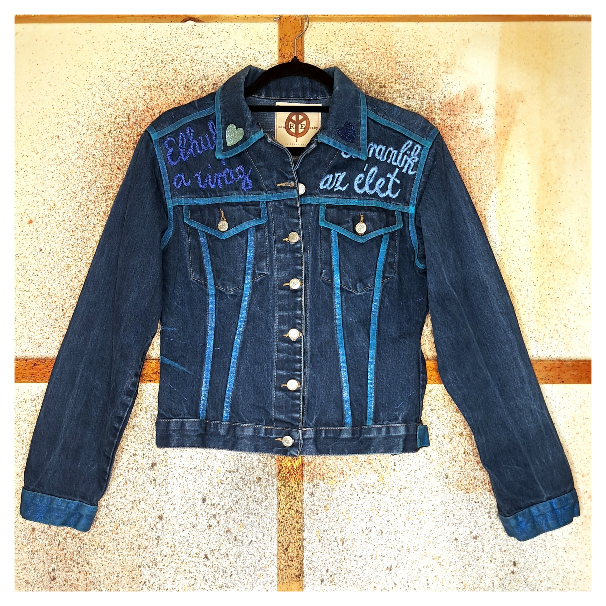 Recycled, upcycled blue denim jacket with hand embroyed with glitter skull on back